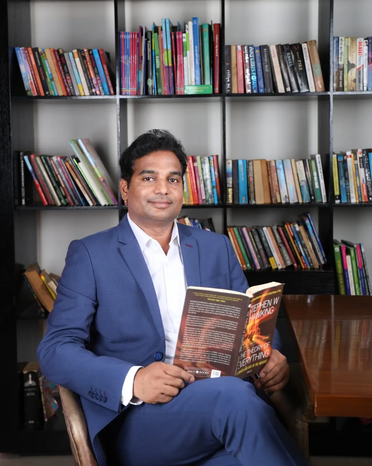 Corporate headshot of a business leader holding a book, shot by Sparkeye in Gurgaon